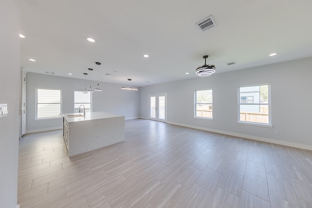 interior space with french doors, light hardwood / wood-style flooring, and sink