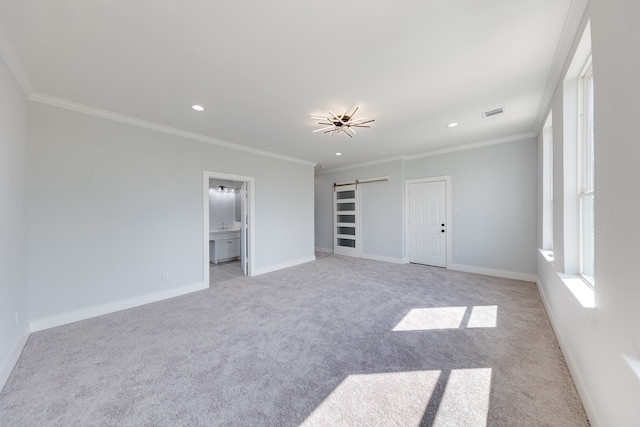 unfurnished bedroom featuring ornamental molding, a barn door, connected bathroom, and light colored carpet