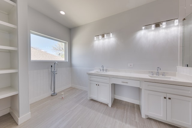 bathroom featuring built in shelves and vanity