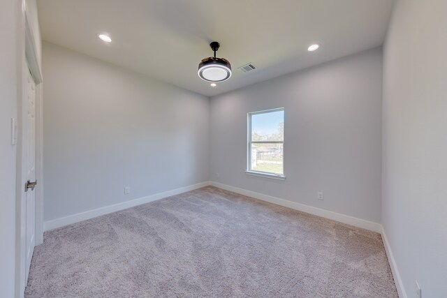 unfurnished room with light colored carpet