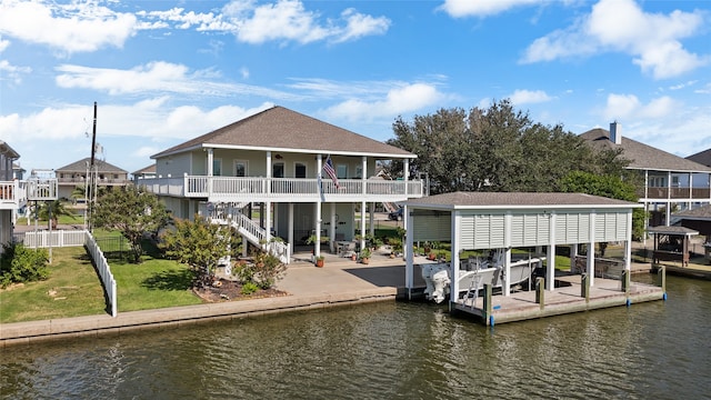 dock area featuring a water view and a lawn