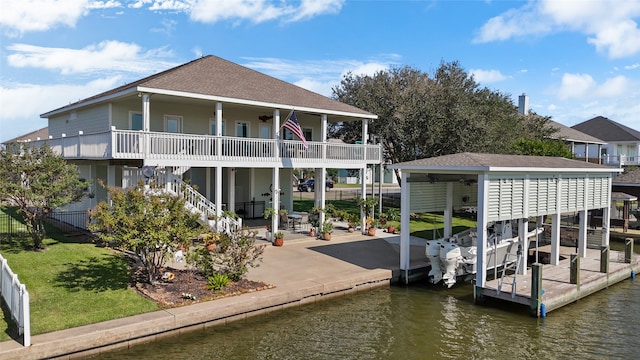 view of dock featuring a water view and a yard