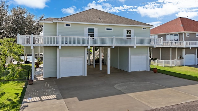 rear view of house featuring a garage and a carport