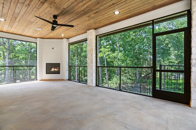 unfurnished living room featuring wooden ceiling and a healthy amount of sunlight