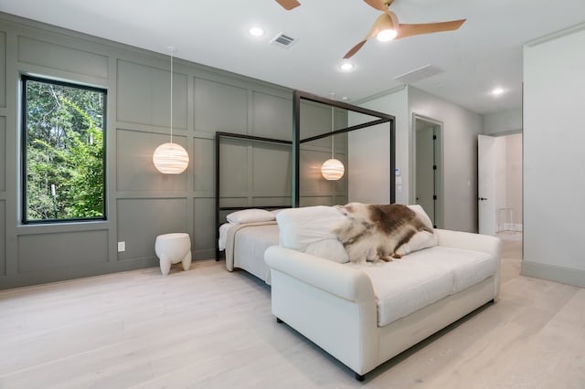 bedroom with ceiling fan and light hardwood / wood-style flooring