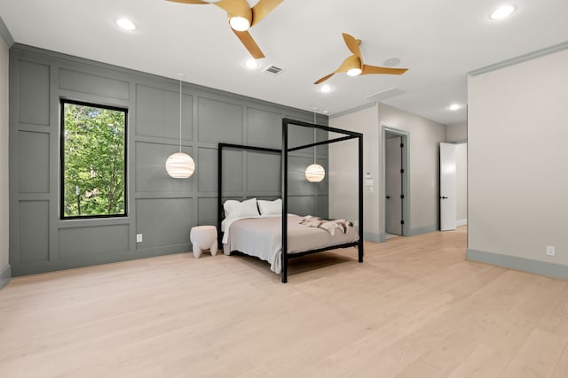 23560 High Meadow Estates Dr, Montgomery, TX 77316 - bedroom with a decorative wall, light wood-style flooring, recessed lighting, a ceiling fan, and baseboards