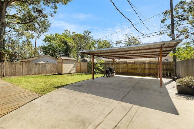 view of patio / terrace with a shed and a carport