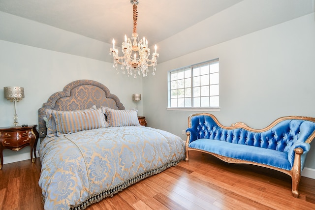 bedroom featuring a chandelier and wood-type flooring