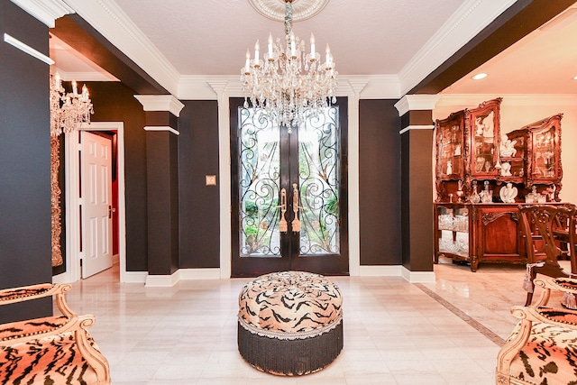 entrance foyer with french doors, decorative columns, and ornamental molding