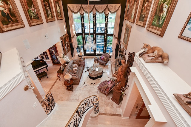 tiled living room with a towering ceiling and french doors