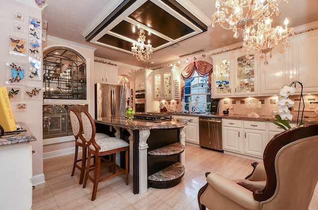 kitchen with stainless steel appliances, dark stone counters, pendant lighting, and crown molding