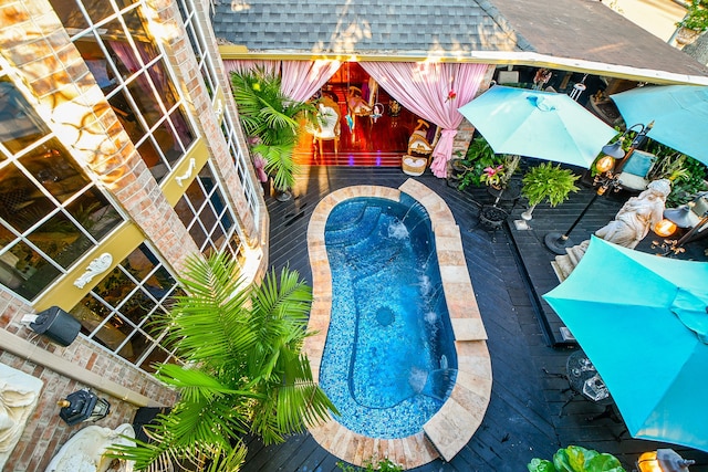 view of pool featuring a deck and a jacuzzi