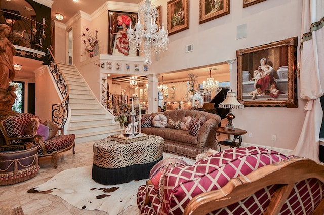 living room featuring ornate columns, ornamental molding, an inviting chandelier, and a towering ceiling