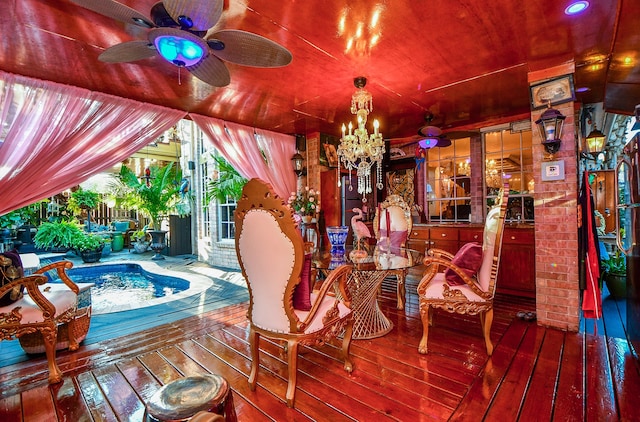 dining area featuring ceiling fan with notable chandelier and hardwood / wood-style floors