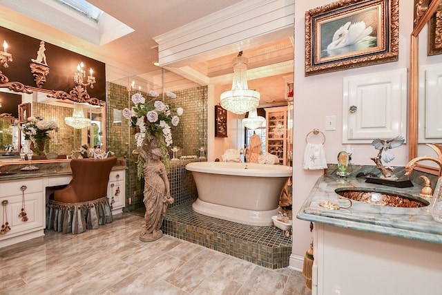 bathroom with a skylight, vanity, and shower with separate bathtub