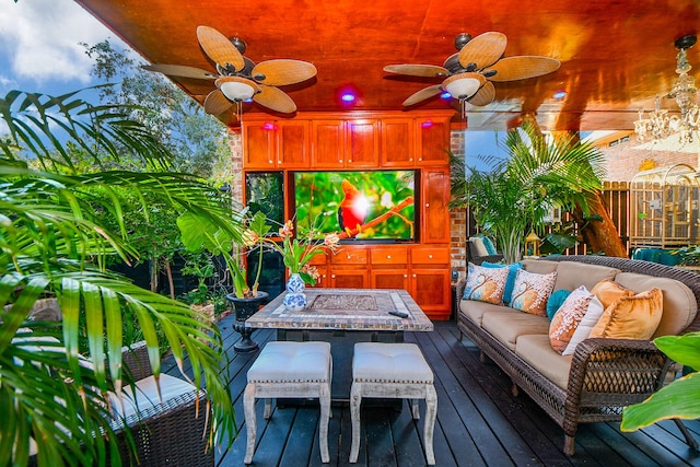 wooden deck with ceiling fan and an outdoor hangout area