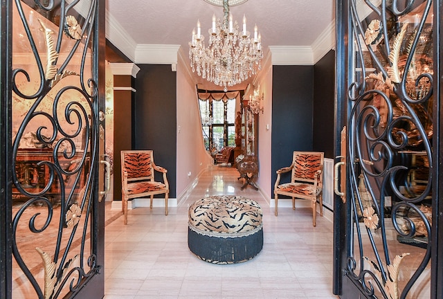 foyer with ornamental molding, a chandelier, and a textured ceiling