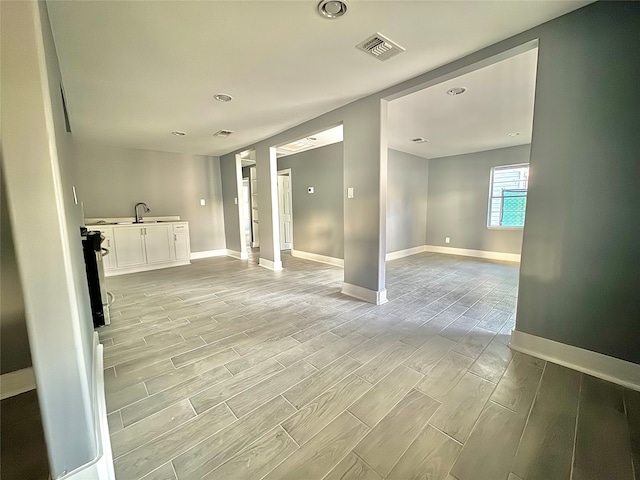 empty room featuring sink and light hardwood / wood-style floors