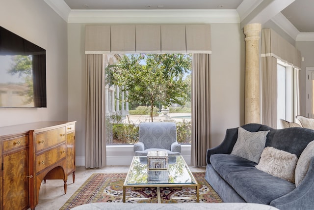 living room with ornamental molding and ornate columns