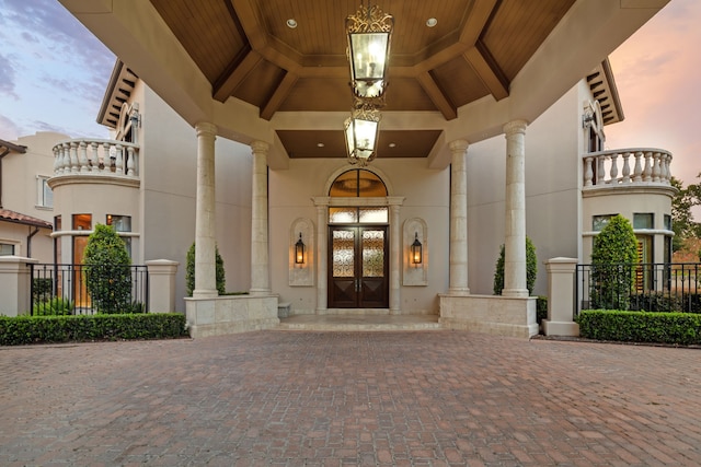 exterior entry at dusk featuring french doors