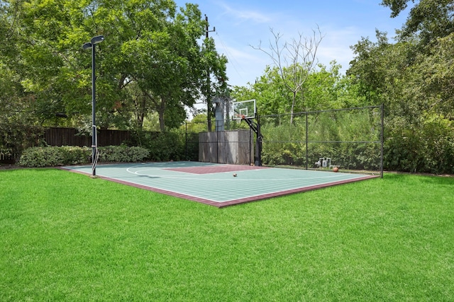 view of sport court featuring a lawn