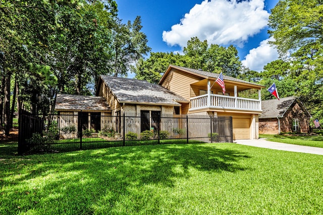 view of front facade featuring a garage, a balcony, and a front lawn