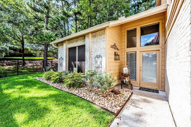 doorway to property featuring a yard