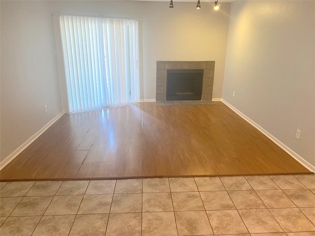 unfurnished living room with light wood-type flooring and a fireplace