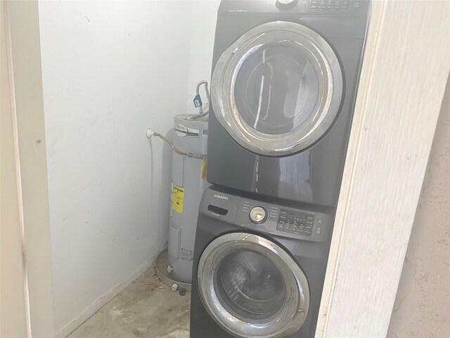 laundry area with stacked washer and clothes dryer and water heater