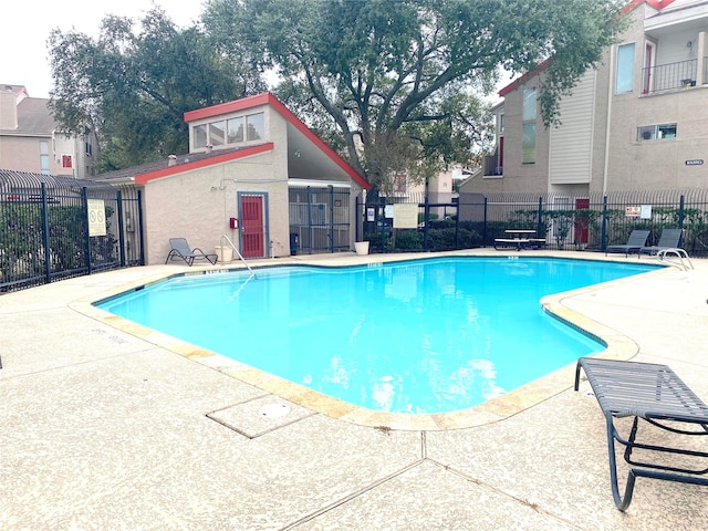 view of swimming pool with a patio area