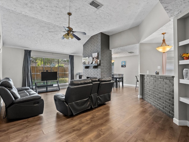 living room with ceiling fan, hardwood / wood-style floors, and vaulted ceiling