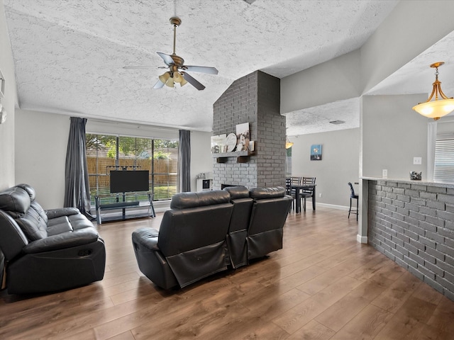 living room featuring hardwood / wood-style floors, ceiling fan, and lofted ceiling