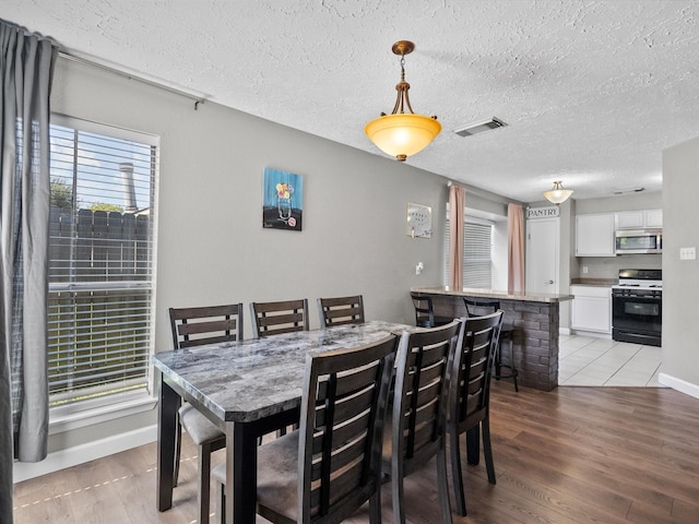 dining area featuring light wood-type flooring