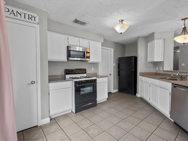 kitchen featuring light tile patterned flooring, sink, white cabinets, and black appliances