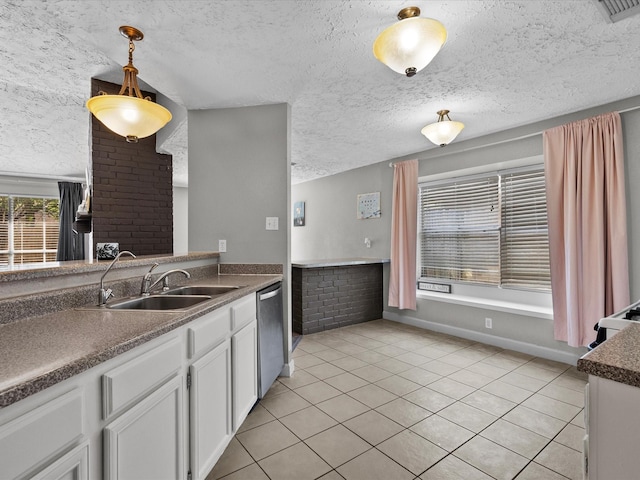 kitchen with white cabinets, stainless steel dishwasher, hanging light fixtures, and sink