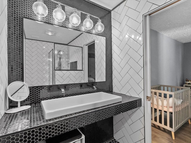 bathroom featuring hardwood / wood-style floors and a textured ceiling