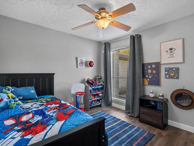 bedroom featuring a textured ceiling, ceiling fan, and dark wood-type flooring