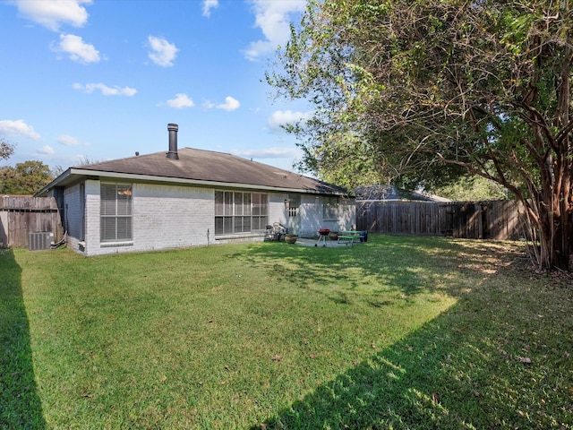 back of property featuring a yard and central air condition unit