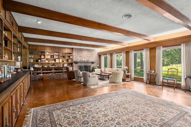 unfurnished living room with wood-type flooring, a textured ceiling, a fireplace, and beam ceiling