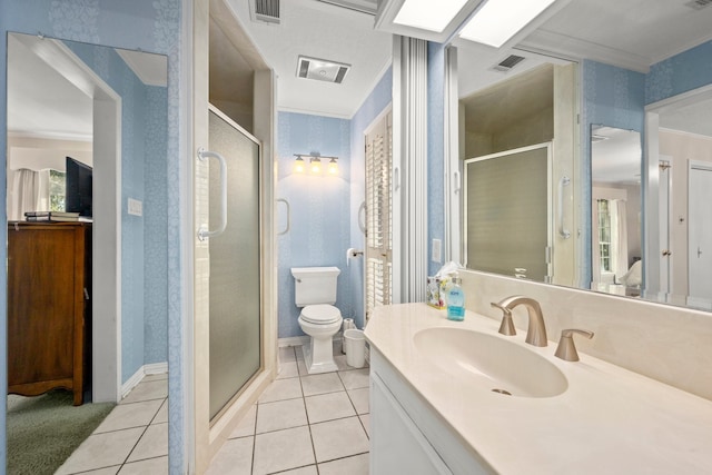 bathroom featuring tile patterned floors, an enclosed shower, vanity, and toilet