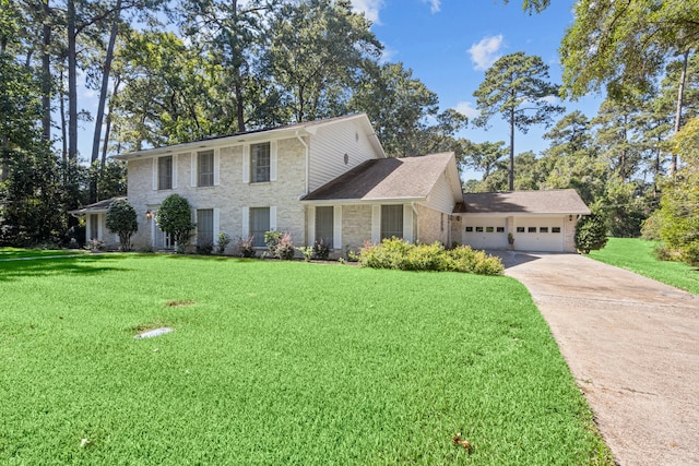 colonial house featuring a front yard and a garage