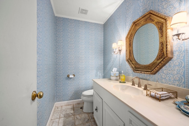 bathroom featuring ornamental molding, vanity, and toilet