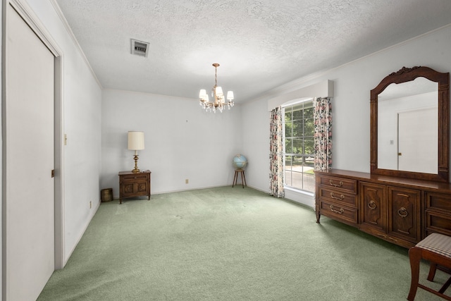 interior space featuring a closet, crown molding, an inviting chandelier, and a textured ceiling