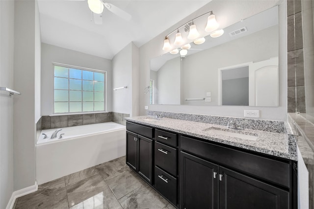 bathroom with a bath, vanity, vaulted ceiling, and ceiling fan