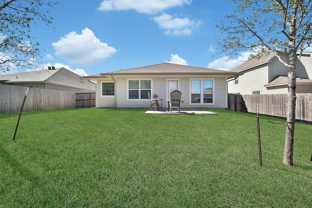 rear view of house with a yard and a patio area