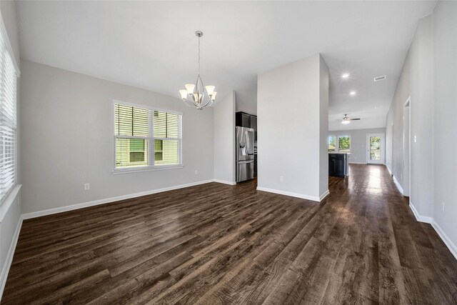 interior space with dark hardwood / wood-style flooring and ceiling fan with notable chandelier