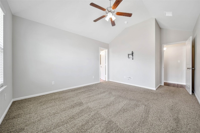 carpeted empty room with ceiling fan and vaulted ceiling