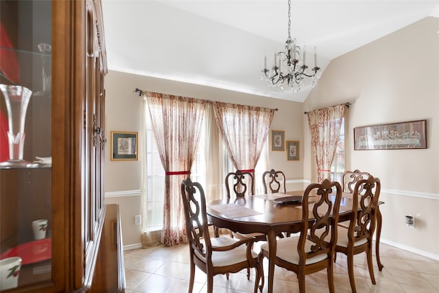 dining area with lofted ceiling, an inviting chandelier, and light tile patterned floors