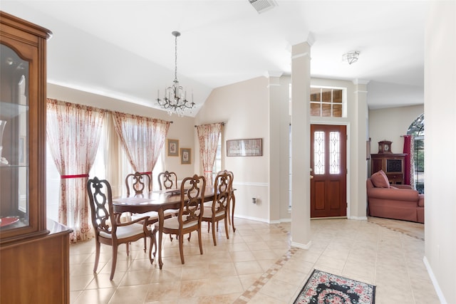 dining space with decorative columns, light tile patterned floors, vaulted ceiling, and a chandelier