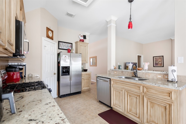 kitchen with pendant lighting, sink, appliances with stainless steel finishes, light stone countertops, and ornate columns